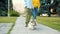 Tilt-up of happy young people walking welsh corgi dog in urban park kissing