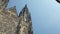 Tilt up panoramic view from ancient gothic church St Vitus cathedral to blue sky in Prague