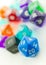 Tilted macro of blue twenty sided dice with other dice