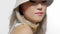 Tilted up portrait of blonde korean model with fresh natural makeup wearing a bucket hat