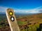 A tilted, weathered, wooden footpath sign on Foel Fenlli on the Offa\'s Dyke path in the Clwydian Range in North Wales.