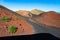 Timanfaya volcanoes  park, Lanzarote, Canary Islands, Spain. Unique panoramic view of winding road across huge volcano cones