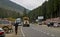 A timber carrier with cargo transports logs along a mountain road.