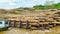 Timber loaded into big barge then drag by a tugboat cruising Mahakam River