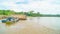 Timber loaded into big barge then drag by a tugboat cruising Mahakam River