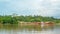 Timber loaded into big barge then drag by a tugboat cruising Mahakam River