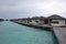 Timber pier with bungalow at island resort Maldives