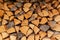 Timber stock for winter. Dry logs of wood in the background. Sale of wood.