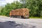 Timber truck with a forest rides on the highway with cargo