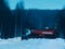 Timber truck full of wood driving along snowy road