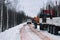 Timber truck loaded with logs driving snowy road