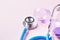 Time check up and Time management. stethoscope and broken hourglass on pink background