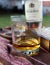 Time for drink - a glass of whisky on a garden table