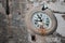 Time Flies: An Antique Circle Street Clock on an Old Wall with Flying Pigeon - Vejer de la Frontera, Cadiz, Spain