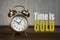 Time is gold concept - golden alarm bell clock