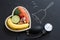 Time for health heart abstract diet food concept on blackboard with bell