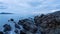 Time-laps of amazing golden light sunset sky and clouds flowing over tropical sea with rocks in the foreground Stunning clouds flo