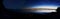 Time laps panorama: Lake with a sunset on the right and the night star sky on the left