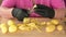 Time laps video of a woman\'s hands in black gloves to peeling potatoes