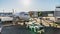 Time-lapse of airplane landing and docking at airport terminal gate, airport staff security check and unloading luggage