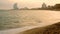 Time lapse of barceloneta beach in barcelona at sunset with people and clouds in motion and landmark