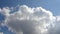 Time lapse of beautiful white fluffy clouds moved by the wind in a deep blue summer sky