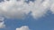 Time lapse of beautiful white fluffy clouds moved by the wind in a deep blue summer sky