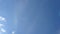 Time lapse of beautiful white fluffy clouds moved by the wind in a deep blue summer sky