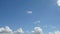 Time lapse of beautiful white fluffy clouds moved by the wind in a deep blue summer sky