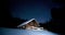 Time-lapse. Beautiful wooden house in the winter forest under the stars