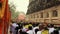 Time lapse of buddhist monks exiting from temple after pryers in line at day from flat angle