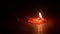 Time-lapse of a candle burning out on wooden table. Fire flame fading out, the light disappeared, in dark environment. End of life
