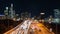 Time-lapse of car traffic transport on multiple lanes highway road, financial district buildings at night in Philadelphia, USA