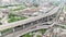 Time-lapse of car traffic transportation on elevated highway, road intersection, sky train railway, with under construction site