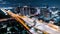 Time-lapse of car traffic transportation on highway road, toll gate at night. Cityscape view with construction crane on building