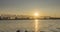 Time-lapse of city river bank. Sun rays, blue sky and railway bridge over horizon. Summer sunset time with flat tiny