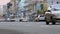 Time-lapse city street at daytime, cars drive fast, low angle
