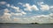 Time lapse clip of several fluffy curly rolling cloud layers in windy weather on lake