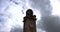 Time-lapse of clock tower with moody clouds