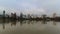 Time lapse of clouds and auto traffic downtown Portland Oregon with city skyline and water reflection