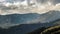 Time lapse of clouds moving above mountain peaks at sunset