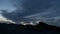 Time lapse of clouds over desert rocks