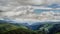 Time lapse clouds over green alpine meadow