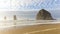 Time lapse of clouds and sky over Haystack Rock at low tide along Pacific Ocean in Cannon Beach OR 4k