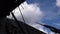 Time lapse of clouds through view of derelict building roof rafters