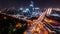 Time-lapse of construction site at night, car traffic transportation on road in Asia city, high angle view