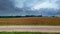 Time lapse of countryside road, crops and clouds