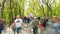 Time lapse of crowd of people walking at you with blurred images on the background of nature