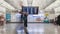 Time-lapse of crowded people checking arrival departure board and walking in Hong Kong airport terminal