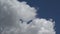 Time-lapse of a cumulus cloud moving against a blue sky